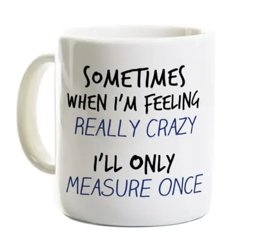 White ceramic coffee mug with Measure Twice Cut Once woodworking slogan