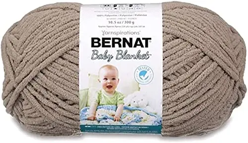 Bernat Baby Blanket yarn in baby sand color showing its plush chenille texture