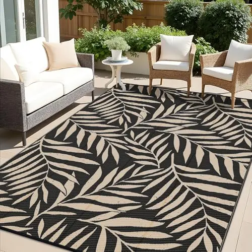OLANLY reversible outdoor rug with tropical leaf design in black and beige