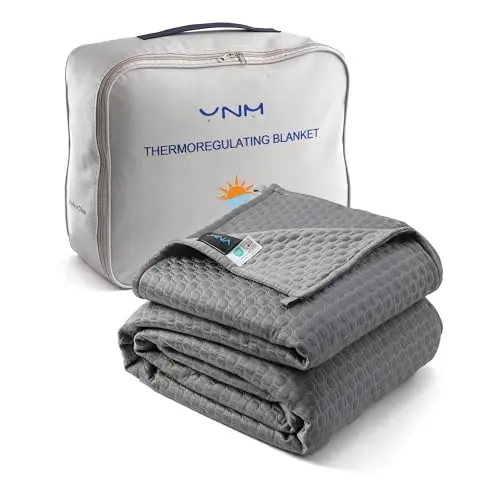 YnM thermoregulating blanket on a couple's bed