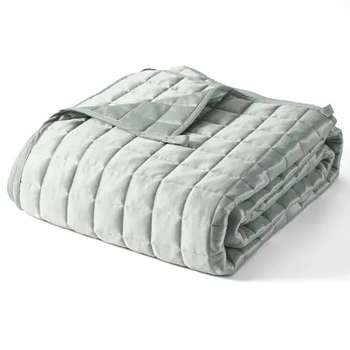 YNM cooling weighted blanket draped over a bed